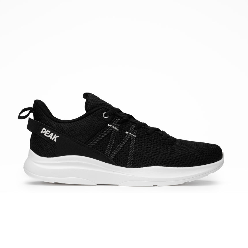 Sneakers Peak pour homme en noir et blanc, design sportif et minimaliste, avec maille respirante et semelle légère offrant confort et maintien pour le running et la marche quotidienne