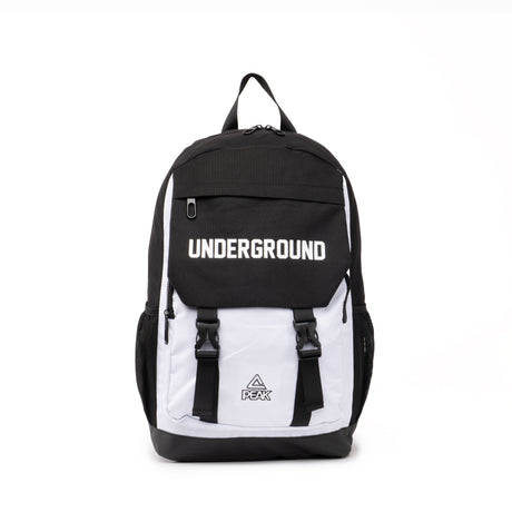 Black and white PEAK backpack with 'UNDERGROUND' text on the front flap and buckle straps, displayed on a clean white background