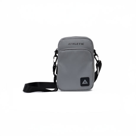 Grey PEAK crossbody athletic bag with black adjustable strap and front zipper pocket, displayed on a clean white background